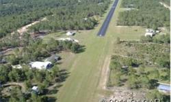 SELLER FINANCING price is $65,000 with a $5,000 down payment. CASH PRICE is $55,000. 4.85 acres, high & dry, level, part-wooded, fronting paved road in Airstrip Community. Natural clearing for home site with gorgeous view and privacy. Access to large