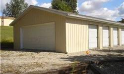 24x62 building southwest of Spencer on Pottersville Rd. Building offers: 1 24x32 garage with 3 small overhead doors and 1 large 16ft. overhead door, 2 8x24 storage units with roll up overhead doors, 1 14x24 storage unit with overhead door plus side entry