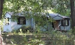 Nice wooded land with good road frontage. Easy commute to Richmond or Tappahanock. Older house on property is not liveable and value is in the land. Being sold strictly AS IS. Buyer should satisfy themselves as to the possible existence of any well or