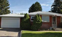 BRAND NEW CARPET AND BEAUTIFUL HARDWOOD FLOORS!!! This great little house is move-in ready and situated on a huge lot just steps from the elementary school. The main floor features a very large living room with beautiful hardwood flooring and a wonderful