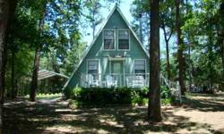 RETREAT TO LAKE CYPRESS SPRINGS! Adorable A-Fame cottage nestled in a canopy of mature trees. Enjoy the peaceful atmosphere while enjoying nature at its best. Listen to the birds tweet and watch the deer play in your yard. Several outside settings to