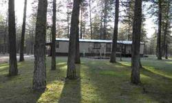 Fabulous setting on over 8 acres and treed. This 2 bedroom manufactured home has a open floor plan with additional 8' tip out in livingroom, giving it more of the great room concept. Sprinklers, small out building and you can watch the wildlife from the
