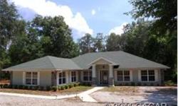 Custom built home located on 6 private, wooded acres on one of Hawthorne's best lakes. The home has 10 foot ceilings w/ cathedral in LR and kitchen area, split floor plan, arched doorways, gas fireplace in LR. Kitchen has ceramic tile, eat-in breakfast