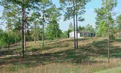 Endless possibilities for this gently rolling 11.5 acres just off State Road 121. Paved road frontage with 2 separate homesites. Existing doublewide manufactured home can be renovated or replaced without paying county impact fees. Well and septic tanks