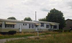 This 2 bedroom 1 bathroom mobile home is 840 sq feet and has a 2 car detached garage! Nice wood paneling in kitchen, and throughout. Bi-level living room, lots of shelving. Above ground pool in the back yard, shed as well! We offer flexible financing with