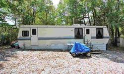 You could own a great place to get away for the weekend. This lot has a 1992 Dutch camper on it, all set up for you with appliances. utility shed on property with water, electric, window unit, washer and dryer. Camper has a holding tank for sewer.