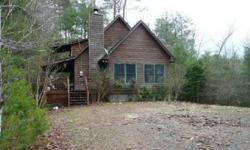 Cabin with quiet, private, wooded lot - amenities include a wrap-around deck, wood-burning fireplace, loft, sunporch, and detached garage. Daniel Kane Parker has this 2 bedrooms / 2 bathroom property available at 46 Blackberry Falls Ln in Ellijay, GA for