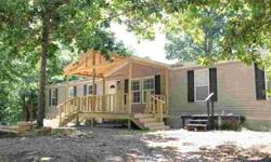 Wonderful, newer manufactured home on 33.33 ACRES! This 2005 model has 2,128 sq. ft., 4 bedrooms, 2 bath, a living room, family room and a new covered front porch. It's in very good condition and sits tucked into the woods but is just miles from