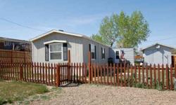This 2000 model 2 bedroom 1 bath home is located on 3 lots right in Lambert. Included are two storage sheds, a built on entryway, and newer fence. The large lot and extras make this a very nice set up. Propane tank and kitchen appliances are included.