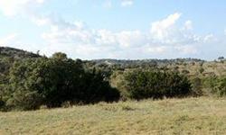 Estate lot with dramatic views of the scenic Texas hill country. Lot is predominately level and located at the end of a cul-de-sac on Kite Drive within the estate section of Comanche Trace. 3500 sq.ft. minimum build requirement - home plans to be