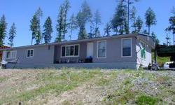 Beautiful views of surrounding mountains! 1960 sq. foot, 4 bedroom, 2 bathroom manufactured home on 8.59 acres within 9 miles of Colville. Open floor concept with large country style kitchen, huge living room, good size bedroom. Bring your building plans