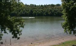 Taneycomo Lake front/Lake View condo in Branson, rarely available in Paradise Shores, secluded & quiet location. Includes Boat slip w/lift & Boat (owner says runs well) 2 covered carports & plenty of storage! Refreshing Park-like Beach front, mowed to the