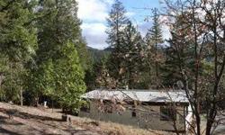 Above the fog on 4.88 treed acres. Prestine property with Firs, Pines and Madrones. Cute home warmed by a wood stove and decks off of two sides to enjoy your private forest. Located between Jacksonville and Applegate Lake, only about 15 minutes to either.