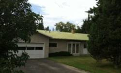 One level home near Woodland Park. It features a large yard with fruit trees and large area formerly gardened, an auxiliary building used as a woodworking shop, could be used for many other things. The house has hardwood floors throughout, some now