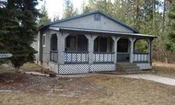 Take A Look At This One! CLOSE-IN PROPERTY, BUT VERY SECLUDED! This is a stick-built, 1-level home on a great 10 acre parcel. Stucco exterior, wood floors and laminateinside. There is a wood stove in the living room. Wired for generator. The 30' x 40'