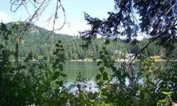 Lovely Hayden Lake Waterfront! .63 acres nestled amongst impressive homes and quaint lake cabins. Varied topography, stream, wooded privacy, deep water privacy and lake and mountain views. A peaceful waterfront setting within Close proximity to town and