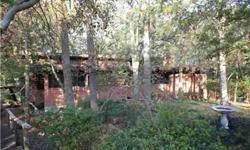 This home is being sold as is. Extremely cool mid-century modern home designed by William Kellett. Needs TLC - but has great potential! On a private heavily wooded corner lot. Plenty of room with 5 bedrooms, 3 baths, 2 living, 2 dining, plus a study.