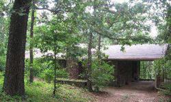 Wooded retreat! Darling rock home on 2.52 acres with a pond. Just minutes from HWY 412-W & I-540. 3 bedrooms, 1 bathroom, 2 living areas & walk-in closets. A huge covered front porch overlooks lush foliage. All appliances including the refrigerator,
