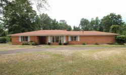 Large 3 bedroom, 2 bath brick home with two living areas, breakfast and formal dining, and 2 car carport. Main living room features a wood burning fireplace. The home sits on a 1.13 acre lot. Exterior also features a storage building and greenhouse.Call