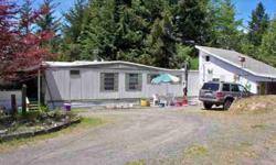 Parklike 5+ acres with excellent building site. Well maintained singlewide with slide out and addition. Lifetime roof. Bright Sunporch area and front deck. Second building on property could be shop, storage, etc. Near to dune access and beaches.Listing