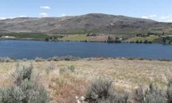 Affordable 5.07 ac. Vacation Retreat! Sunshine over 300 days a year. Views of the Columbia River, Mountains & Orchards for miles. Recreation Galore. Fish Salmon & Steelhead. The Okanogan & Methow Rivers Very Close by. Game Hunting. Boating, Skiing, Jet