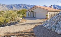 Sitting high atop a hill, this home offers some of the greatest views of the Catalina Mountains that you could get. Located on nearly a 1.25AC lot, youll have country privacy while being able to watch interesting desert wildlife. This charming home is
