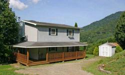 This 2BD/2BA 1.5-story 1235 square foot home sits on a .39-acre lot in The Knolls, a quiet, well-kept neighborhood in the heart of Maggie Valley, NC. Outside, the home features a wrap-around porch - covered on two sides - that ends with an open deck