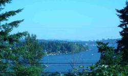 South-West facing, level building lot w/ beautiful views of Lake WA, Carillon Pt Marina, Bellevue City Skyline, and Mt Rainier! Very quiet setting in neighborhood that owns a community beach with moorage available. Short stroll to the beach, tennis