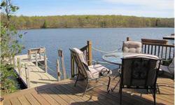 This is the home you have been waiting for! Enjoy this gorgeous lake front right from the rear deck or the many windows in the large living room overlooking the lake with a beautiful stone fireplace. This is the perfect weekend retreat or year round home