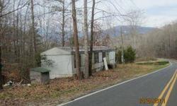This .50+/- acre lot is level to sloping with road frontage on Oakdale Road. The mobile home is older and in very poor condition and may or may not be inhabiitable without improvements. The value of the property is actually in the lot with well and septic