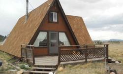 SELLER MOTIVATED,POSSIBLE OWNER CARRY WAC,Solar retreat, 10 acres fully fenced and gated. 1592 sq' A- Frame, 2 BR, 1 BA. New Outback Solar System with new Kohler Backup Generator. Forever views, private yet easy access via county maintained road. Just