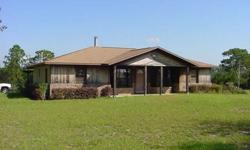 Well maintained concrete block home on 2 fenced acres. 3 bedroom, 2 bath home on paved CR326 across from Oak Ridge Training Center. Split bedroom open floor plan with custom fireplace/wood stove, ceramic tile and wood floors, inside laundry and large