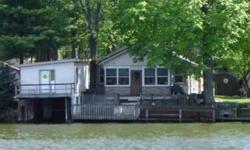 Quaint cottage on main Lake Shafer. Lots of potential! Cottage feel with hardwood floors. Large living areas. Lakeside enclosed porch. Deck overlooking the waterfront. Concrete seawall. Enclosed boat house with storage above.
Listing originally posted at
