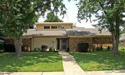 Two mature trees shade this well-maintained and updated home in Plano. In the den a stained wood beam accents the vaulted ceiling while a ribbon of windows at ceiling height allow natural light to brighten and enlarge this inviting room. Anchoring the den