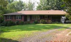 Classic brick ranch with full basement. Main level includes open family room with woodstove, kitchen with dining area, formal living room, 3 bedrooms, and 2 baths + screened porch and carport. Basement features rec room with fireplace, kitchen, BR, bath,