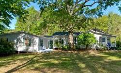 Enjoy a quiet, natural setting on 1.4 acres w/in 5 min. to Beaufort waterfront, 20 min. to Cherry Pt. & close to shopping/schools. Spacious home w/major renovations & an addition in 98. Features incl. lrg cozy living rm w/hardwood flrs, country style