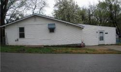 Tremendous opportunity in this unique fixer-upper. This property sits on a large, fenced lot. It has vinyl siding, newer kitchen cabinets, and newer bath fixtures. Bring your hammer and paintbrush to restore the unique floor plan. Selling as-is. Proof of