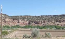 360 Views! Nestled beneath the Red Rocks of the Escalante State Park and by the Escalante River, this is a beautiful parcel. 11 acres of pasture, 8 shares of irrigation water, ALL utilities are on the property, easy access. Free mobile home to live in