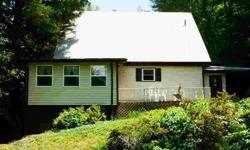 Sweet A-frame chalet with huge potential on nearly six private and completely unrestricted acres. One bedrooms downstairs and one upstairs along with a large loft. The basement, is 485 sqft of already heated and almost finished, now used as a family room,