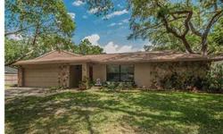 Great Value in the Highly Desirable Bay Woods Neighborhood in Safety Harbor. This wonderful family home is spacious light and airy with new paint throughout. The flooring is all tile or laminate. The large family room with real wood burning fireplace sits