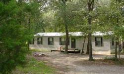 This 3 bedroom, 2 bath manufactured home with over 1600 sq ft of living space is privately situated on 11.35 Acres of rolling hills and pretty oaks. Like golf? This property was formerly used as a 9 hole golf course. It comes with irrigation system, 600