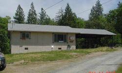 Nice rural property in Grants Pass. Has a good size barn, 3.8 acres. Huge double-level deck on back of house. Cute kitchen with some appliances, vinyl floor. Large & spacious layout. Family area has built0in shelving. Nice size bedrooms. Just a lovely