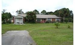 Check out this location. Almost an acre (.89) on Highway 54, less than a half-mile from the Suncoast Highway and many new businesses. Spacious cement block/brick front home features large living room and brick fireplace. Has formal dining room,