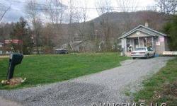 Over 1/2 flat acre on Richland Creek. Small house (as is). Zoned R-1 with secondary Commercial. Town of Waynesville says you can have almost any type business here but must verify with them first. If want access to inside house, need 24 hours notice. In