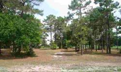 Large, nearly one acre wooded lot, fronting the number 1 green on the Members Club golf course. Great location for building your future dream home in St James Plantation. The lot is located off the main thoroughfare of Members Club Blvd. It is easy to