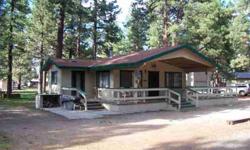 This is a great property. It is 1.1 acres adjacent to forest land. It is 3 parcels with two that are developed. The frunished cabin is 1048 square feet, 2 bed, 2 bath, laundry room. Big deck partially covered. The 2 car garage has a furnished studio
