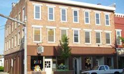 Large 6 unit investment property located in the heart of downtown West Liberty. Property features 2 retail store front units on the first level & 4 residential units on the second level. The building also features a full basement & a third story for easy