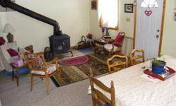 RED FARMHOUSE next to RUSHING STREAM!! Lots of character and charm; woodstove in living room; windows overlooking the brook. Walk to the Black River or Echo Lake!! Lake Ninevah a few miles upstream; 2 car attached garage with wood shed. Only five minutes