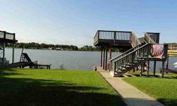 This cozy 2 bedroom, 1 bath, fully furnished (w/flat screen TV and DVD surround sound) home in Conroe Bay has a gorgeous lakefront view! A great galley kitchen offers plenty of counter space and cabinet storage, as well as a breakfast bar and breakfast