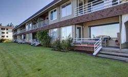 Live in a beachfront community! Ground floor two-bedroom condo with a sweeping 180 degree view of Puget Sound, Vashon Island, and the Olympic Mountains. Tastefully remodeled kitchen and informal dining room provide a wonderful view. Large living room with